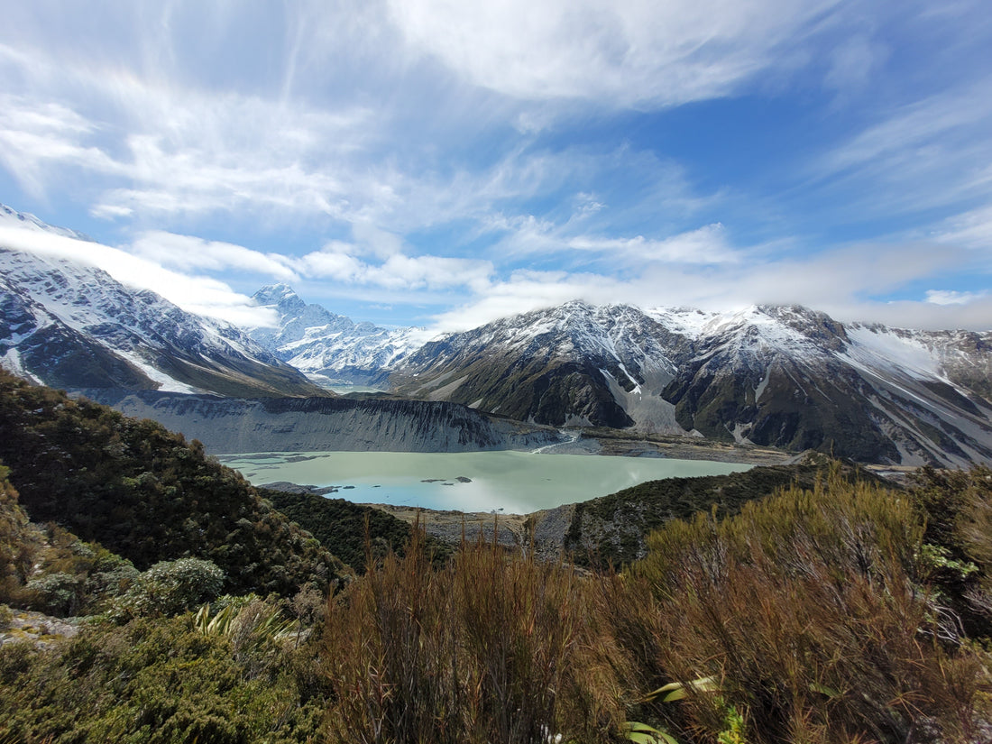 The stunning view over Mueller Lake towards Aoraki/Mount Cook on a raw New Zealand hiking tour in the Southern Alps.
